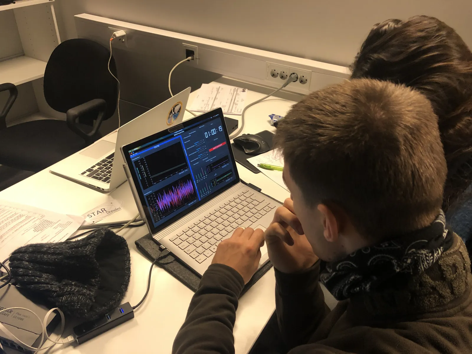 A team member watching live pressure plots on a laptop